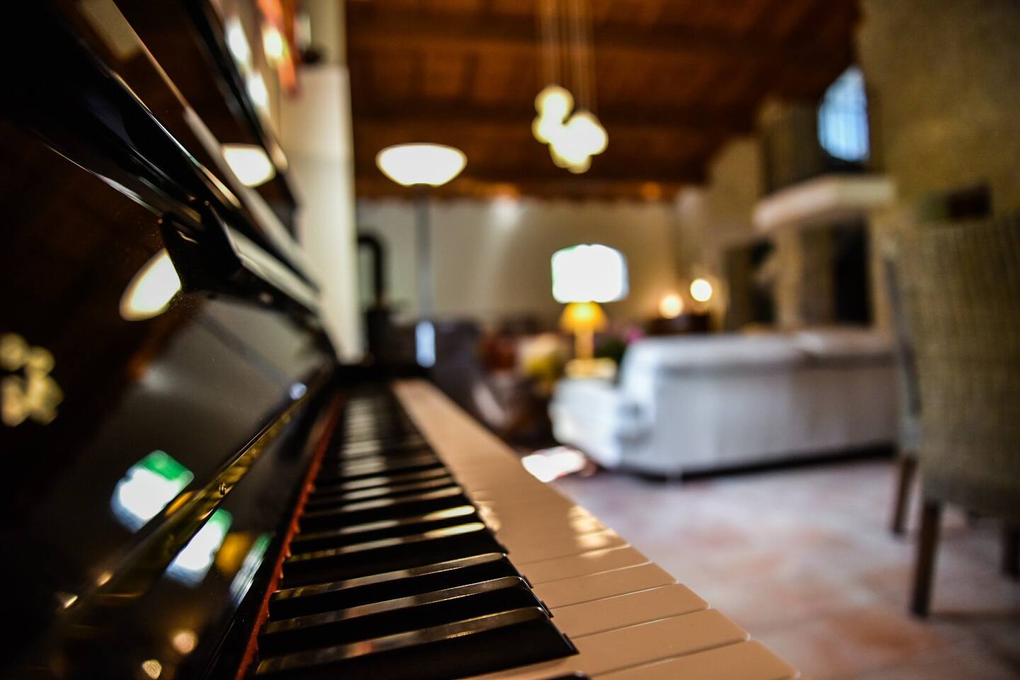 The upright piano, in the living room