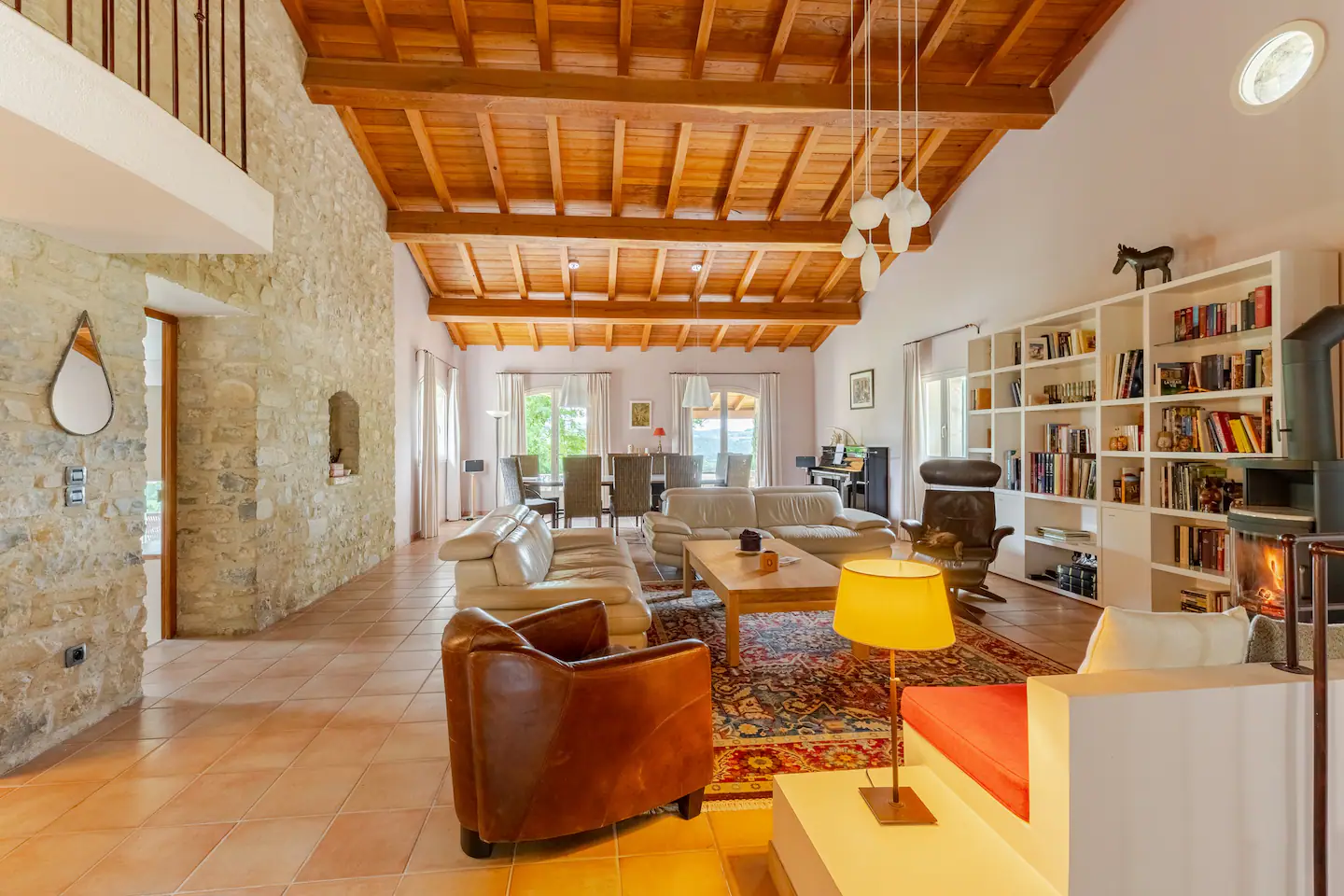 The grand living room, fireplace and library under the timber roof